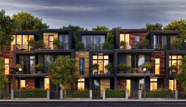 Modern townhouses undergoing exterior home remodeling, featuring balconies and surrounded by lush green trees in a vibrant urban setting.