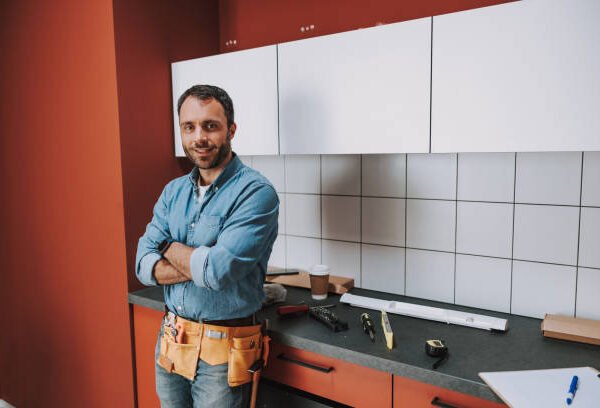Top-rated kitchen remodel contractor in San Jose standing confidently in a newly renovated modern kitchen.